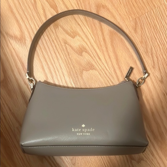 kate spade Handbags - Kate Spade Gray Curved Shoulder Bag with Silver Hardware